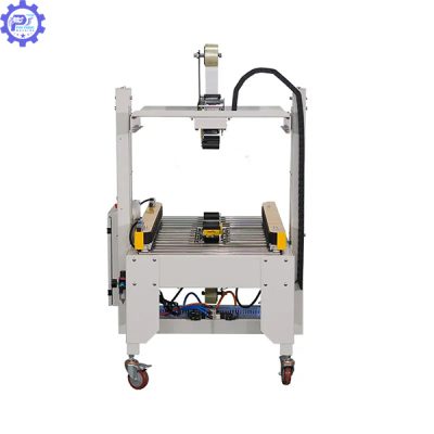 Máy dán băng dính thùng carton tự động gắp mép